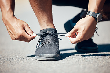 Image showing Man, hands and tie shoes on road for fitness, running exercise or cardio workout outdoors. Hand of male person, athlete or runner tying shoe getting ready for exercising or training on asphalt street