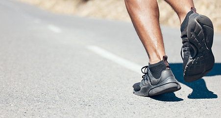 Image showing Man, fitness and running shoes on road for exercise, cardio workout or training on asphalt outdoors. Feet of fit, active or sporty male person, athlete or runner exercising or run on mountain street