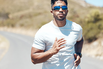 Image showing Man, fitness and running in nature for exercise, cardio workout or training outdoors. Fit, active and sporty male person, athlete or runner exercising on mountain asphalt, road or street outside