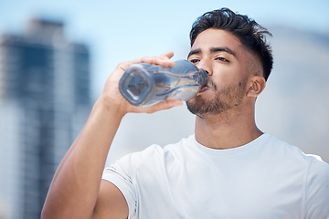 Image showing Man, fitness and drinking water in city workout, cardio exercise or running for sustainability outdoors. Thirsty male person, athlete or runner with drink for hydration, rest or break in urban town