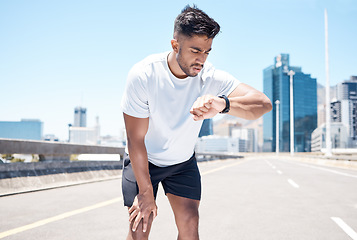 Image showing Fitness, smart watch and man in city for time, heart rate and cardio for running, exercise and workout. Wellness, sports and male person check wristband for marathon training, monitor and performance