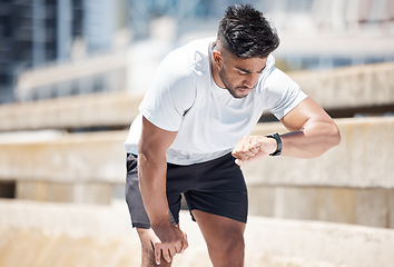 Image showing Man, fitness and checking watch after running exercise, cardio workout or training in city. Fit, active and sporty male person, athlete or runner looking at wristwatch for performance in urban town