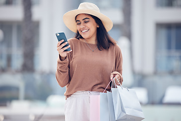 Image showing Shopping, phone and Indian woman in city with bag online for bargain notification, social media and internet. Retail, fashion and female person on smartphone for chat, mobile app and website sale