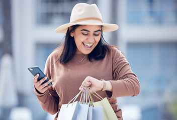 Image showing Shopping, time and Indian woman with phone in city with bag for adventure, rushing and hurry. Retail, fashion and female person check watch with bags from sale, bargain and discount purchase in town