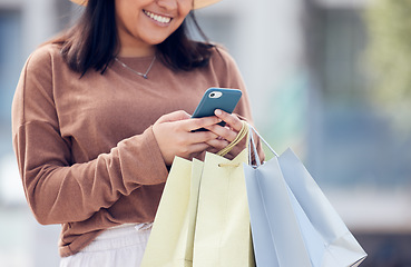 Image showing Shopping, phone and woman typing in city with bag online for sale notification, social media and internet. Retail, fashion and happy female person on smartphone for chat, mobile app and website sale