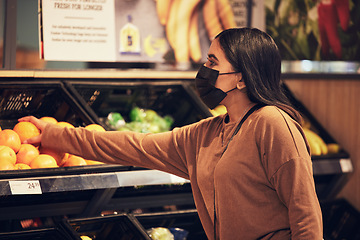 Image showing Grocery shopping, woman and fruit at a retail shop, market and store for groceries with mask. Health, virus safety and female person with orange and healthy food purchase in a supermarket at shelf