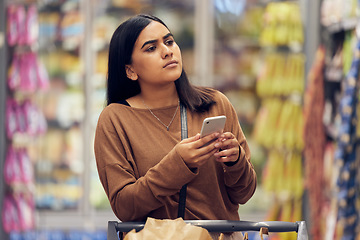 Image showing Choice, shopping and phone with woman in supermarket for grocery, research and cooking app. Product, retail and groceries sale with female customer in store for nutrition, offer and food cost