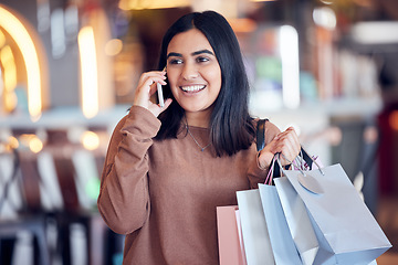 Image showing Shopping, phone call and Indian woman in mall with smile for communication, conversation and chat. Retail, fashion and happy female person talking on smartphone for sale, bargain and discount news