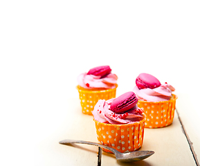 Image showing pink berry cream cupcake with macaroon on top