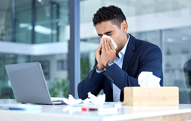 Image showing Sick, sinus and business man with an allergy blowing nose with tissue in an office with a cold or virus infection. Company, worker and young person or employee sneeze at a table or desk while working