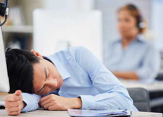 Image showing Call center, burnout or tired man sleeping on table exhausted or overworked by deadlines in overtime. Resting, dreaming or lazy sales agent with stress or fatigue napping on relaxing break at desk