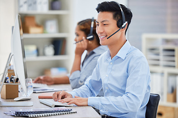 Image showing Business man, telemarketing and call center consultation in a office working on a computer. Smile, male worker and web support advice of a contact us employee with professional communication at job