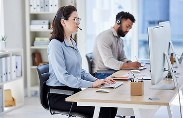 Image showing Business woman, call center and typing on computer in customer service, support or telemarketing at the office. Female person, consultant or agent with headphones on PC for online advice at workplace