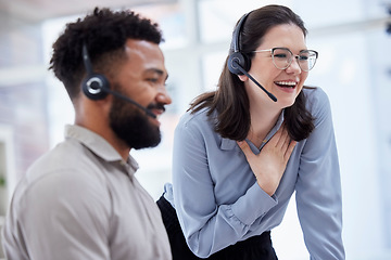 Image showing Cheerful caucasian call centre telemarketing agent training new mixed race assistant on in an office. happy supervisor troub