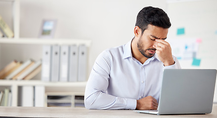 Image showing Mental health, man with a headache and burnout with laptop at his desk at a modern workplace office. Stress or tired, mistake or fatigue problem and male person sad or depressed at his workstation