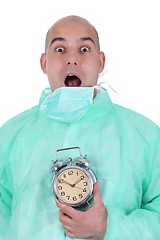 Image showing surgeon and clock alarm