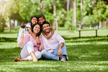 Image showing Portrait, hug and asian family at a park happy, bonding and having fun outdoor together. Smile, love and children with parents on grass ground, embrace and relax while enjoying nature on the weekend