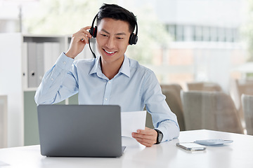 Image showing Asian man, call center and laptop with document in customer service, telemarketing or support at office. Happy male person or consultant agent with paperwork on computer in online advice at workplace