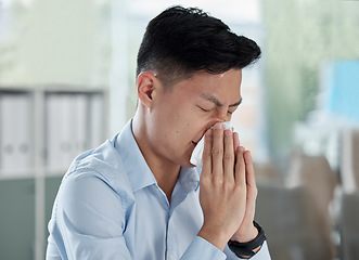 Image showing Sick, blowing nose and virus with asian man in office for illness, influenza and allergy. Sneeze, bacteria and disease with male employee and tissue in corporate business for allergies and congestion