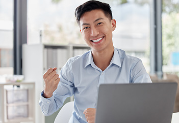 Image showing Happy asian man, laptop and fist in celebration for winning, bonus or promotion at the office desk. Portrait of excited businessman by computer for good news, victory win or success at the workplace