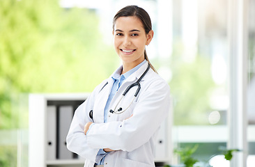 Image showing Portrait, healthcare and arms crossed with a doctor woman in the hospital for insurance or treatment. Medical, happy or smile with a young female medicine professional standing alone in a clinic