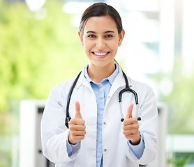 Image showing Thank you, portrait of woman with thumbs up and smile at the hospital outdoors. Success or motivation, review or support and happy female nurse with hand emoji for health wellness or achievement