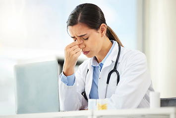 Image showing Mental health, woman doctor sad and with laptop at her desk in a modern office with a lens flare. Depression or headache, problem or burnout and female nurse or surgeon fatigue at her workstation