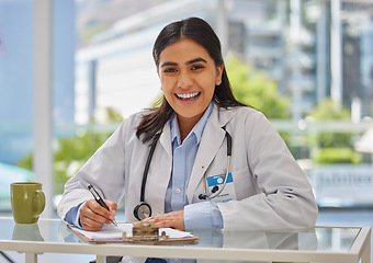 Image showing Medical, happy and portrait of doctor in office for consulting, report and paperwork. Medicine, healthcare and checklist with woman writing in hospital for prescription, wellness exam and results