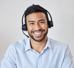 Image showing Portrait of man in call center with smile, headset and happy to help at customer service agency or sales desk. Telemarketing, communication or reception, businessman with cheerful face and headphones