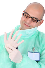 Image showing surgeon putting medical gloves on