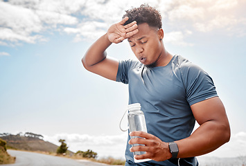 Image showing Fitness, outdoor and black man drinking water, tired and exercise with wellness, health and cardio training. Male person, guy or athlete outside, resting and liquid with practice, sweating and sports