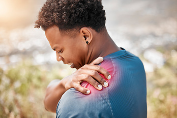 Image showing Fitness, shoulder pain and injury with a sports man outdoor in nature for cardio or endurance running. Exercise, medical emergency or accident with a young male athlete holding a joint while training