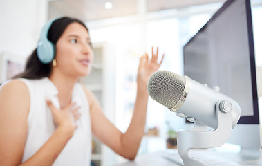 Image showing Blur, microphone or woman live streaming a podcast media or online radio on news broadcast network. Influencer host, blurry presenter or girl journalist reporter talking, recording or speaking alone