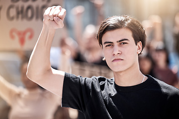 Image showing Fight, protest and man with fist raised for freedom, human rights or equality outdoor in city. Speaker with community people hands and poster or sign for politics, change or reproductive choice rally