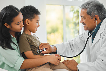 Image showing Doctor checking a kid patient with stethoscope on a sofa for home medicare consultation. Healthcare, pediatrician and mother sitting with her boy child for male medical worker to listen to breathing.