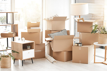 Image showing Cardboard, moving boxes and packing house with furniture, living room decorations and apartment space. Household, packed box and empty property to rent, buy or new home with modern interior
