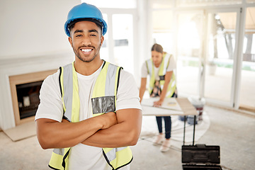 Image showing Portrait of man, construction and home renovation with arms crossed, helmet and smile in apartment. Yes, positive mindset and renovations, happy handyman in safety and building project in new house.