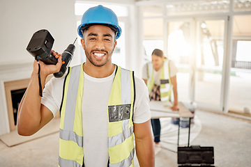 Image showing Portrait of man, construction and home renovation with drill, helmet and working mindset in apartment. Yes, smile and diy renovations, happy handyman in safety and building project tools in new house