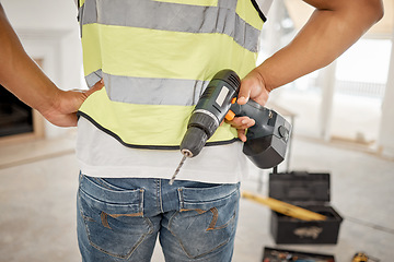 Image showing Handyman, construction and drill in hand of a man for maintenance or carpenter work. Back of male engineer, constructor or contractor worker with electric power tools at building site for renovation