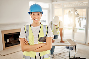 Image showing Portrait of woman, construction and home renovation with arms crossed, helmet and smile in apartment. Yes, positive mindset and renovations, happy female in safety and building project in new house.