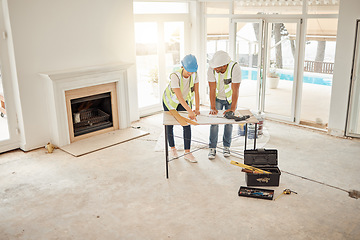 Image showing Architect, construction and home renovation team at table for maintenance or architecture. Engineer man and woman talk and planning strategy with handyman tools for teamwork and collaboration project