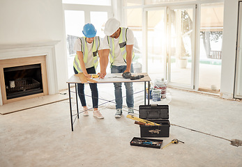 Image showing Home renovation, construction and architect team at table for maintenance or architecture. Engineer man and woman talk and planning strategy with handyman tools for teamwork and collaboration project