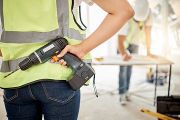 Image showing Construction, handyman and drill in hand for maintenance or carpenter work. Back of engineer, constructor or contractor person with electric power tools at building site for home renovation project