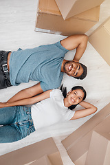Image showing Top view, home and couple with boxes, apartment and excited on the floor, mortgage and relationship. Portrait, man and woman on the ground, cardboard and excited with new house, moving in and growth