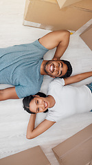 Image showing Top view, home and couple with boxes, real estate and excited on the floor, living room and mortgage. Portrait, man and woman on the ground, cardboard and relationship with property and apartment