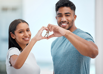 Image showing Hand in heart, key and portrait of couple in new home for property, apartment and real estate investment. Relationship, love emoji and man and woman holding keys for relocation, move and moving day