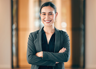 Image showing Portrait, smile and arms crossed with a professional business woman in her corporate workplace. Happy, vision and confident with a happy female employee standing in her office wearing a power suit