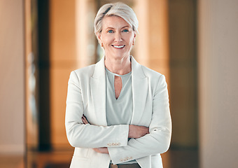 Image showing Portrait, smile and arms crossed with a senior business woman in her corporate workplace. Happy, vision and leadership with a happy mature female manager standing in her office wearing a power suit