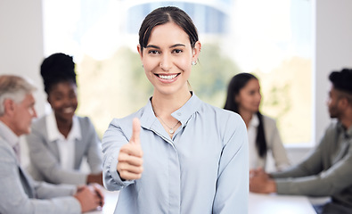 Image showing Portrait, smile and a business woman thumbs up in the boardroom with her team planning in the background. Leadership, workshop and support with a happy young female employee standing in the office