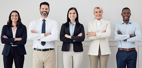 Image showing Portrait, collaboration and arms crossed with a diverse leadership team standing in their professional office. Business, teamwork and management with a group of colleagues looking confident at work